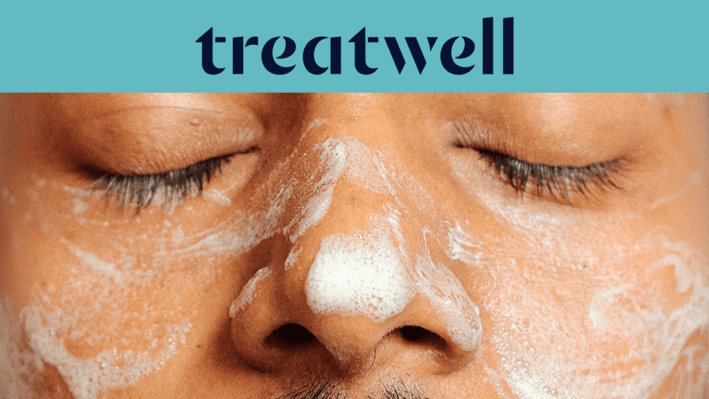A close-up shot of a person's face with their eyes closed, covered in a white foaming facial cleanser. A light blue banner at the top features the "Treatwell" logo in dark blue.